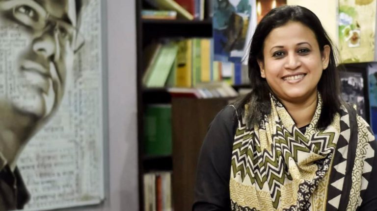 Razia Rahman Jolly stands in front of a mural of her late husband, Faisal Arefin Dipan, at Jagriti Publishing House in Bangladesh